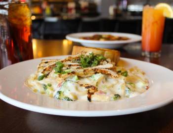 Photo of a pasta dish with cream sauce and chicken