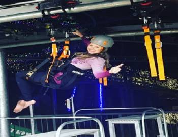 Women ziplining at night