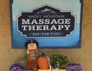 The sign for Smoky Mountain Massage, including logo.
