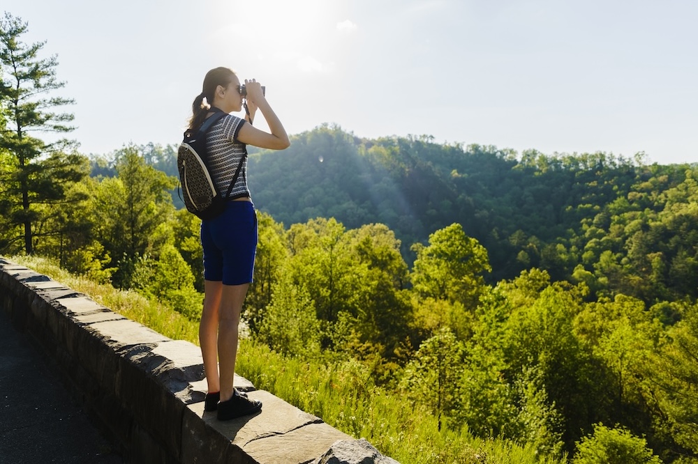 Woman looking through binocular in the Smoky Mountains
